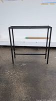 front view of black metal console table