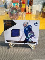 Front of Roberto Luongo Luxury Suite jersey swatch card on stand