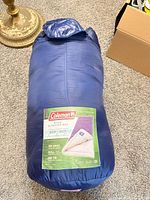 Sleeping bag in navy stuff sack with label visible