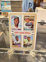 Front of card on stand showing all four miniature card images and overall condition