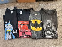Four Batman graphic cotton T-shirts laid flat