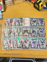 Nine-pocket binder page holding multiple holographic Upper Deck Platinum hockey cards