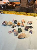 Group view of all polished stones alongside measuring tape for scale
