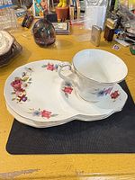 Teacup and two tray saucers showing full pattern and shape