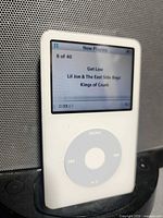 Front view of iPod displaying Now Playing screen while docked
