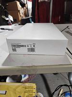 Side of unopened white retail box with product label for ADT Command Touchscreen, showing barcodes and regulatory marks