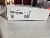 Product label on box showing model STS5200-1, serial number, color white