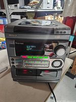 Front view of Aiwa stereo receiver showing display, controls and cassette deck