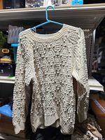 Front view of cream Alyo bobble knit sweater on hanger