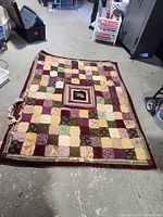 Full view of patchwork quilt laid flat on floor