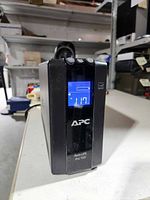 Front view showing APC logo, Back-UPS Pro 700 label and illuminated LCD screen