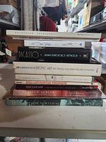 Stack of eleven art reference books showing visible spines and titles