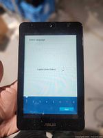 Front view of Asus MeMO Pad powered on to language selection screen