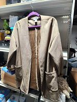 Front view of camel faux suede open front jacket on hanger