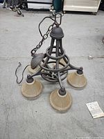 Overall view of chandelier showing frame, five shades, canopy, chain, and wiring