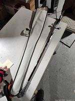 Full view of sword beside carry case