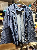 Front view of blue cut-out jacket on hanger