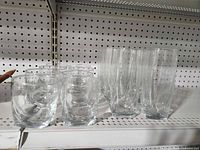 Group of 8 short tumblers and 8 tall highball glasses on shelf