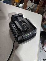 Front and top view of EGO charger showing battery dock and cord