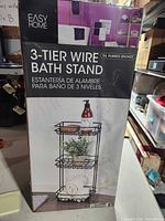 Front of retail box showing Easy Home 3-Tier Wire Bath Stand