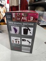Boxed Easy Home mini sewing machine showing product images and features