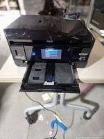 Front view showing powered-on touchscreen and output tray