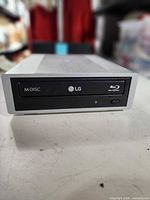Front view showing LG, M-DISC, Blu-ray logos on drive bezel
