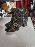 Side view of both boots showing floral pattern and heel