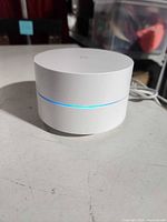Front angled view showing Google Wifi router and blue LED ring