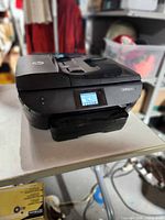 Front view of HP OfficeJet 5745 printer showing control touchscreen and paper tray