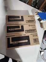 Two Kyocera toner cartridge boxes showing model numbers TK-172 and TK-1142