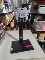 Front view of Lenovo monitor stand showing full structure and red accent