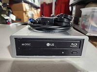Front view showing LG branding, M-DISC and Blu-ray logos on drive bezel