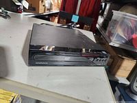 Front view of Magnavox DVD player showing brand, disc tray and controls