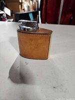 Profile of leather-wrapped desk lighter with chrome top