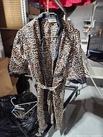 Front view of cheetah print satin robe with belt