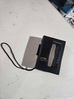 Front view showing Panasonic branding, VAS marking, wrist strap