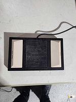 Top view of foot pedal showing three pedal sections and cable