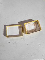 Bracelet inside yellow two-piece box, lid removed