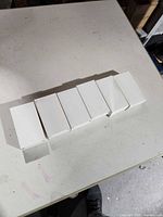 Six white boxes containing the power banks lined horizontally