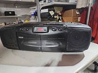 Front view of RCA boombox showing speakers, controls and cassette deck