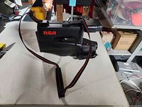 Left side profile of RCA camcorder showing strap and overall condition