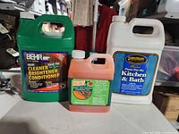 Front view of three sealed jugs: Behr cleaner, Citristrip gel, Golden Harvest paste