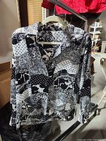 Full view of blouse on hanger showing pattern, style and condition