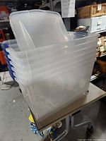 Stack of six clear Sterilite totes nested together with lids