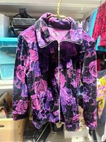 Front view of Style & Co. purple floral zip sport top on hanger