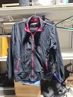 Front view of navy jacket with pink zip and pockets