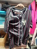 Front view showing button closure, pinstripes, Thrill patch