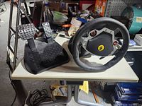 Steering wheel and two-pedal unit on table
