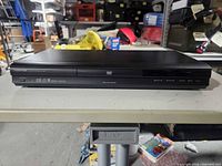 Front view of Toshiba DVD player showing disc tray and control panel